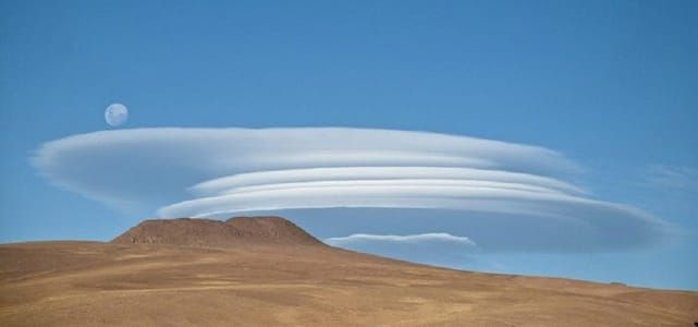 Artwork Title: A full moon rising over lenticular clouds in Llullaillaco National Park, Chile