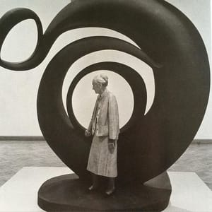 Artwork Title: Georgia O’Keeffe in front of her work titled “Abstraction