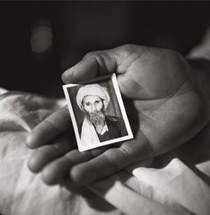 Artwork Title: Haji Abdul holding a photograph of his father