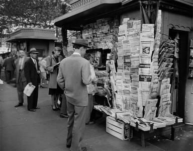Artwork Title: People Browsing Through Magazine Racks At A Busy Sidewalk Newsstand