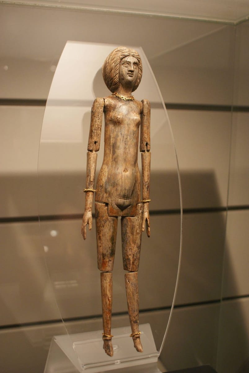Artwork Title: Ivory doll wearing gold bracelets and necklace (found in the sarcophagus of a mummified 8 year old)
