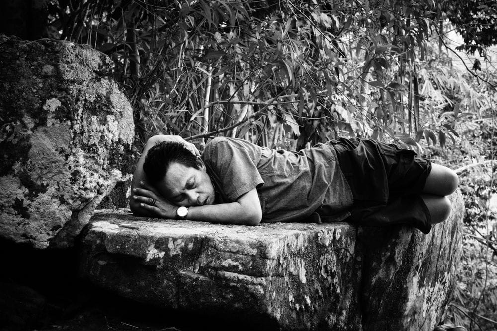 Artwork Title: A man decides to take a nap near to a waterfall in the natural reserve of Thung Tam Sao, Thailand
