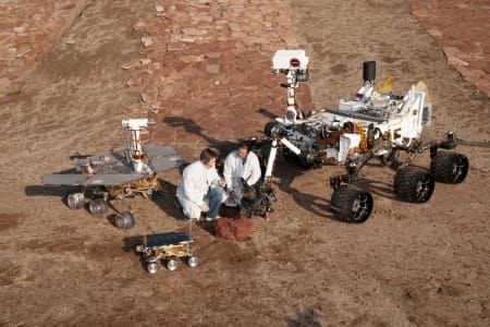 Artwork Title: Three Generations of Mars Rovers With Engineers