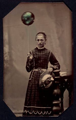 Artwork Title: Young woman holding helium-filled balloon (c.)