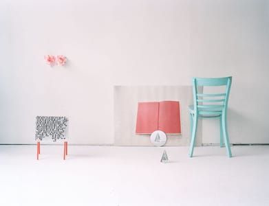 Artwork Title: Two glass pyramids, a book, a chair