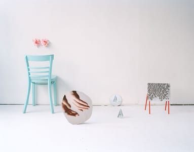 Artwork Title: Two glass pyramids, a chair and the hands