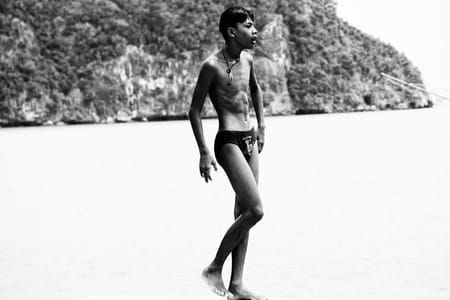 Artwork Title: Young Thai swimmer walks on the edge of the dock, preparing to jump into the sea