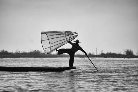 Artwork Title: The waiting fisherman drives his boat to find the best place to throw his net and wait for the scare